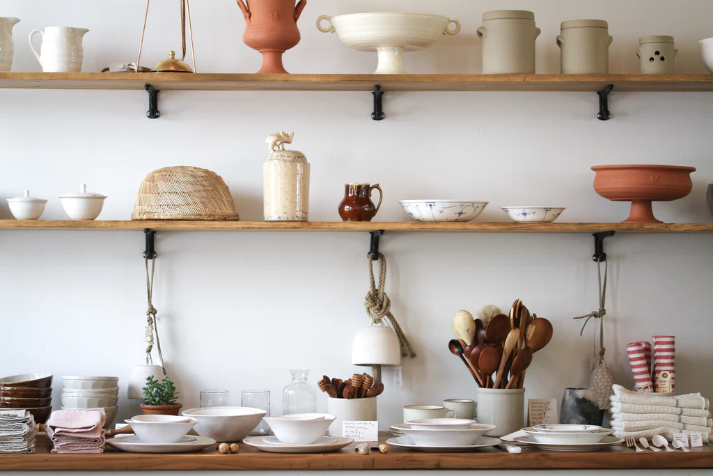 Shelves with ceramic pitchers, bowls, and jars